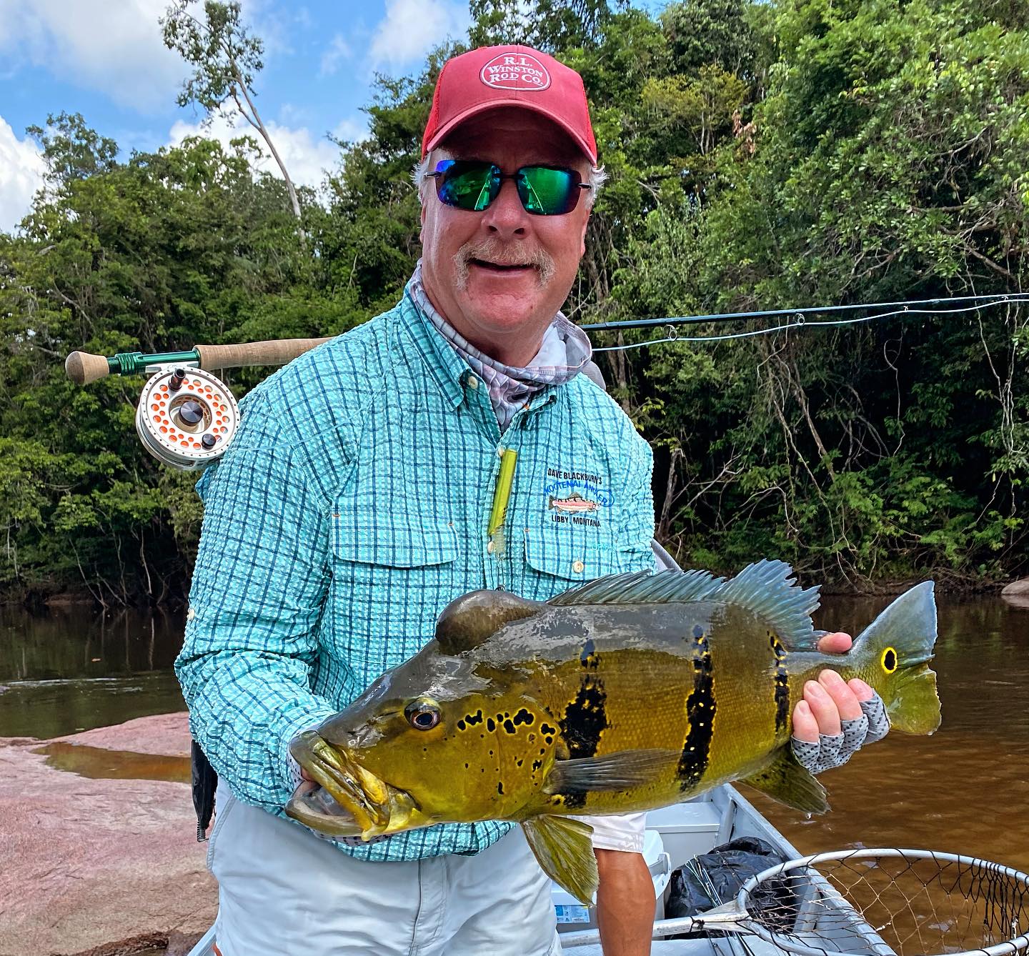 Dave Blackburn Holding tropical fish from the Amazon.